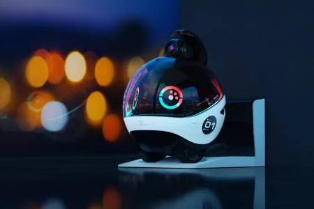 Enabot EBO X with raised camera and illuminated face on a chair