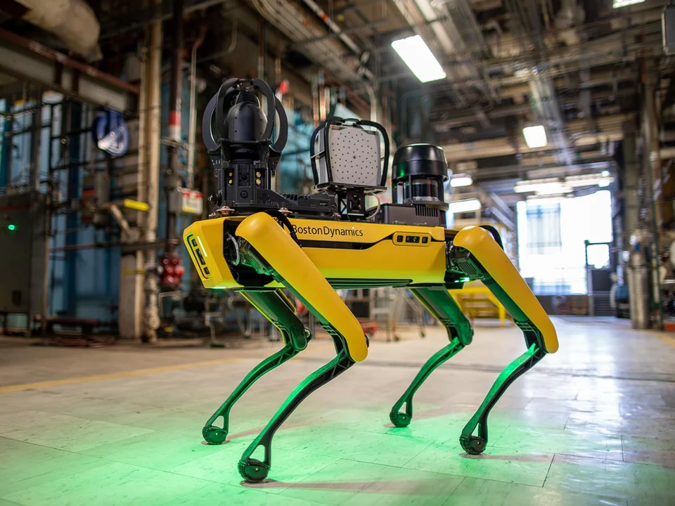 Spot with all four legs visible in an industrial facility